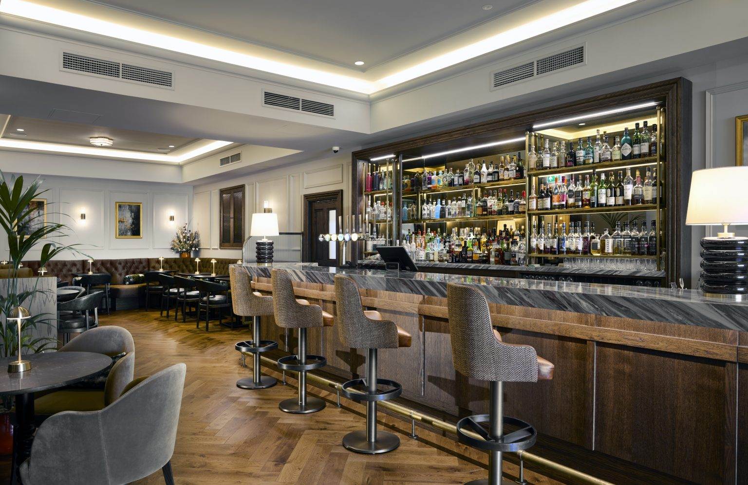 Stylish modern bar fitout with sleek countertop, ambient lighting, and contemporary stools for upscale hospitality spaces