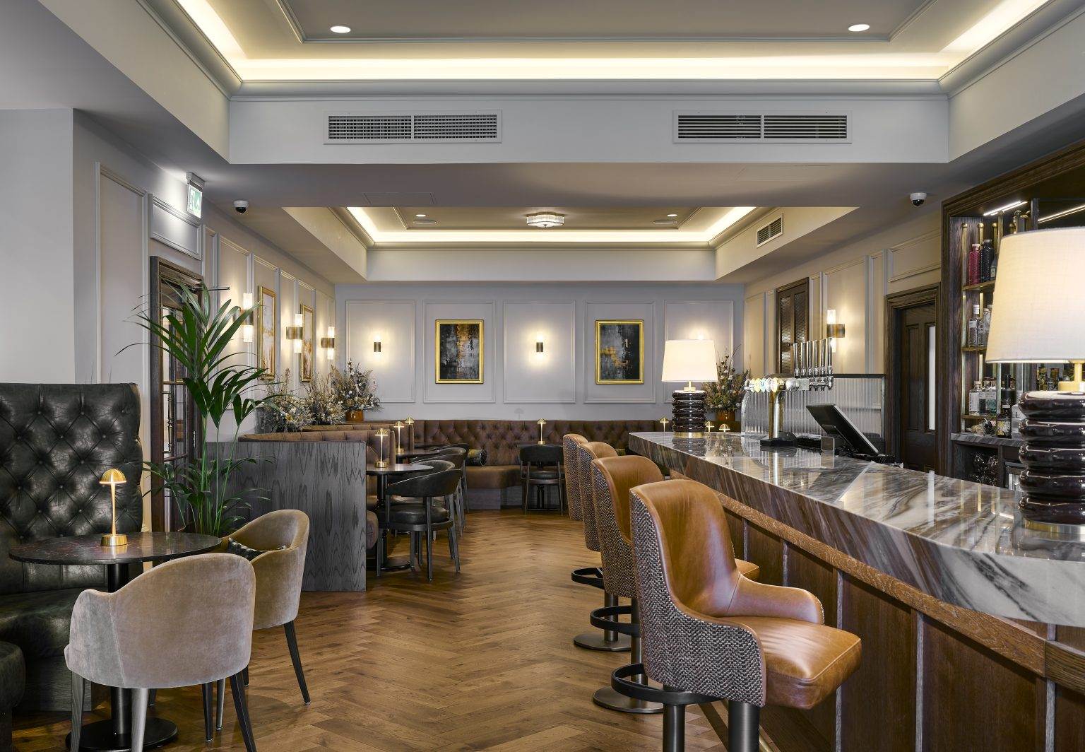 Stylish modern bar fitout with sleek countertop, ambient lighting, and contemporary stools for upscale hospitality spaces