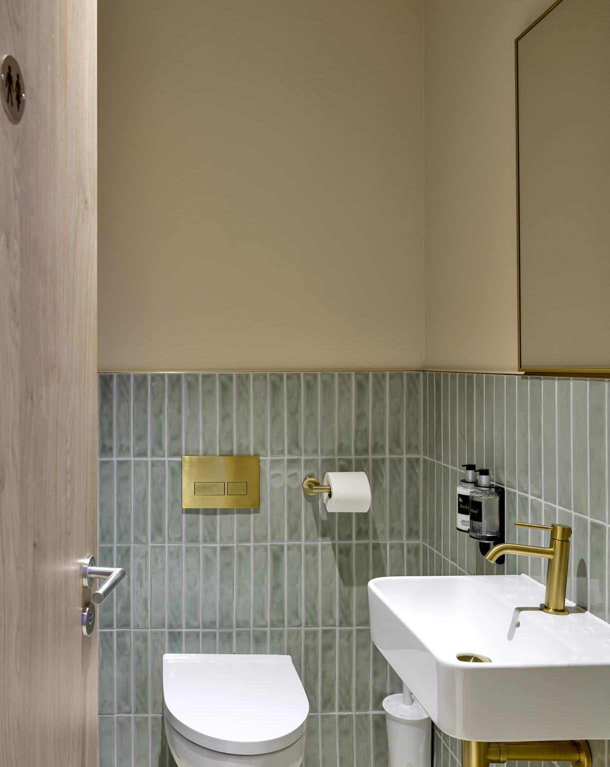 Modern guest restroom with gold accents and stylish fixtures, showcasing the quality of this hospitality fit-out.