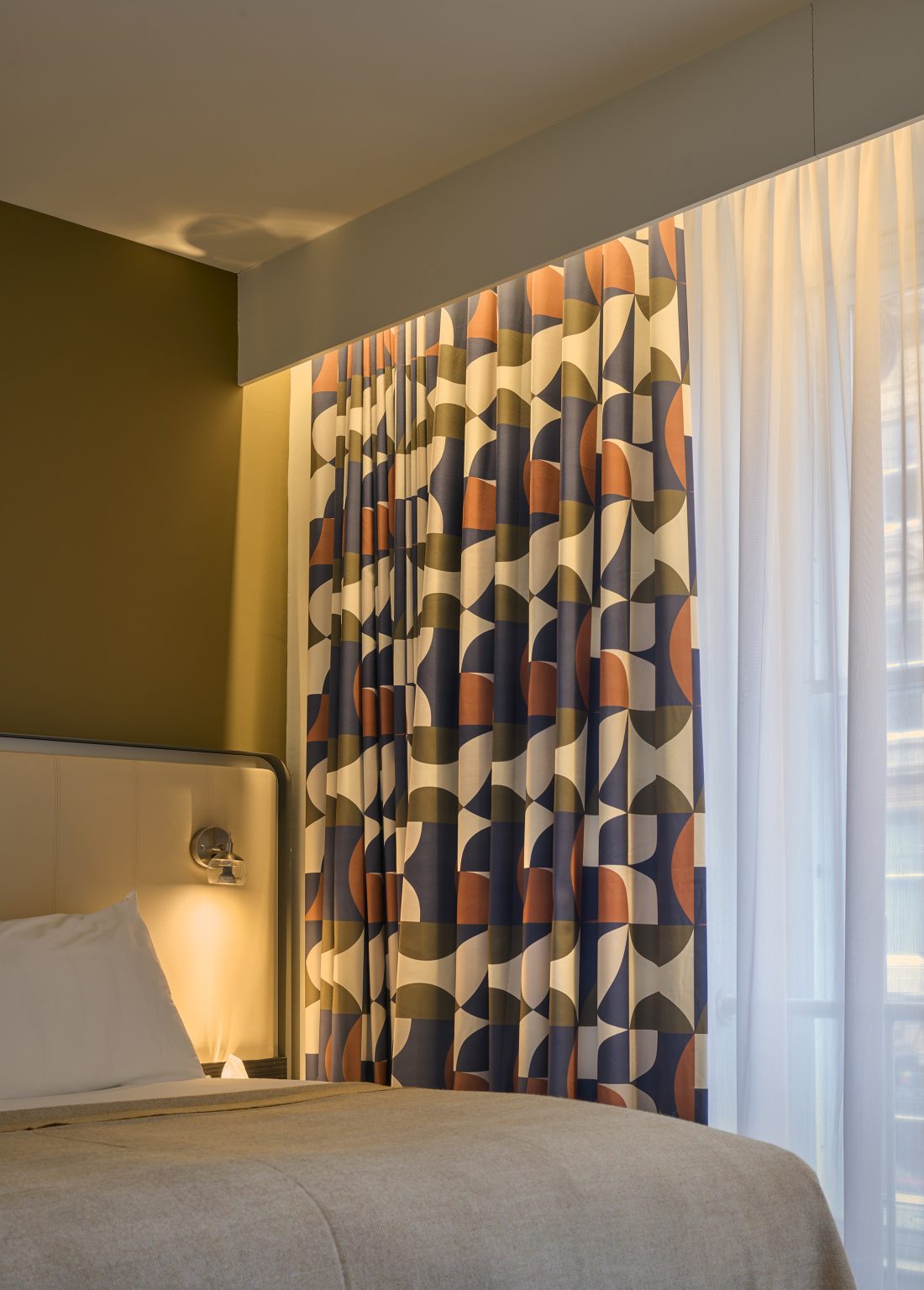 Modern hotel bathroom with illuminated mirror, glass shower enclosure, and sleek fixtures for a contemporary guest experience